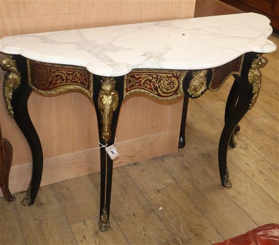 An ebonised boullework marble top serpentine front console table W.130cm